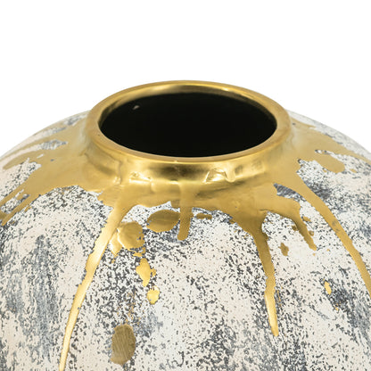 close up of decorative vase with gold accents and a textured surface on a white background