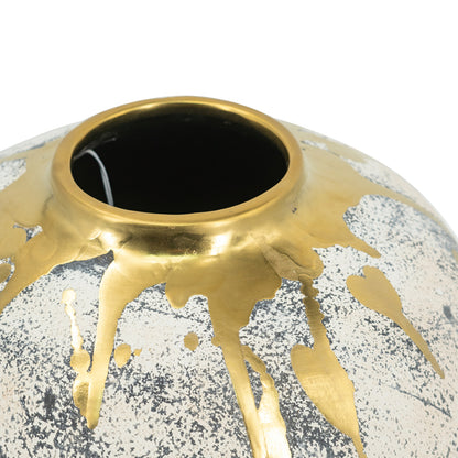 close up of a decorative ceramic vase with gold accents and a textured surface on a white background