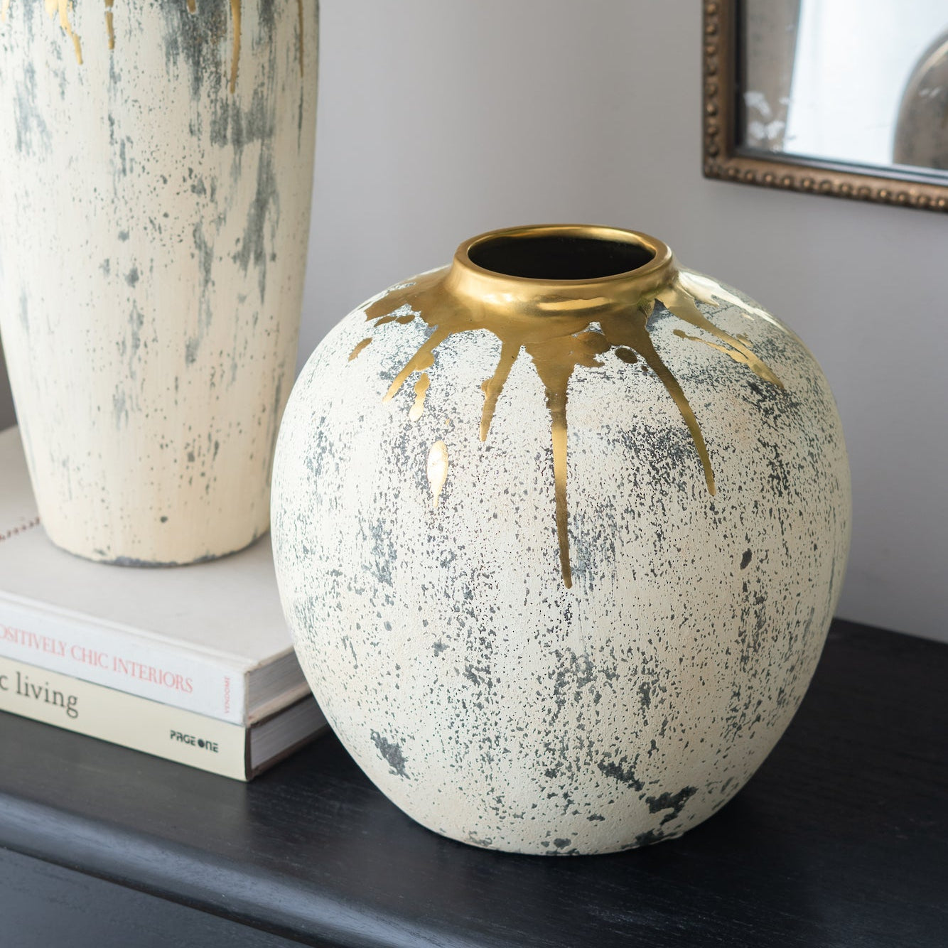 Decorative vase with gold accents on a dark surface.