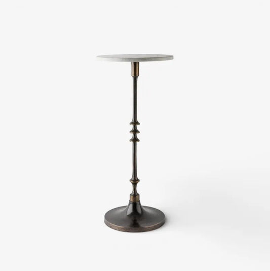 A modern pedestal side table featuring a round white marble top and a dark bronze metal stem with decorative fluted details and a circular base, shown on a clean white background.