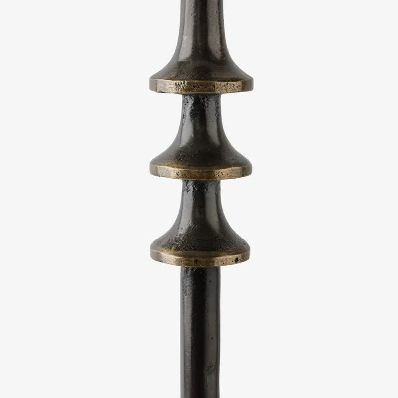 Decorative metal details on a side table, shown on a white background