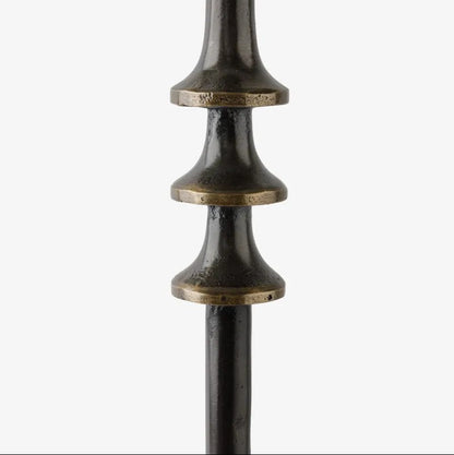 Decorative metal details on a side table, shown on a white background