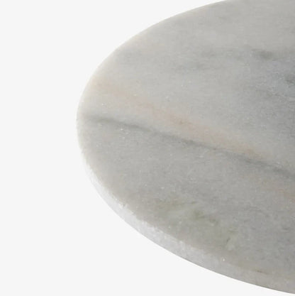 Close up of round white marble table top with a subtle pattern on a white background