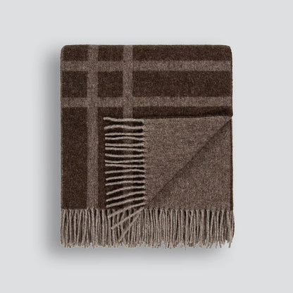A folded brown plaid wool blanket with fringed edges, displayed on a white background.