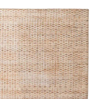 closeup on modern woven rattan headboard in natural beige tones, shown against a white background.