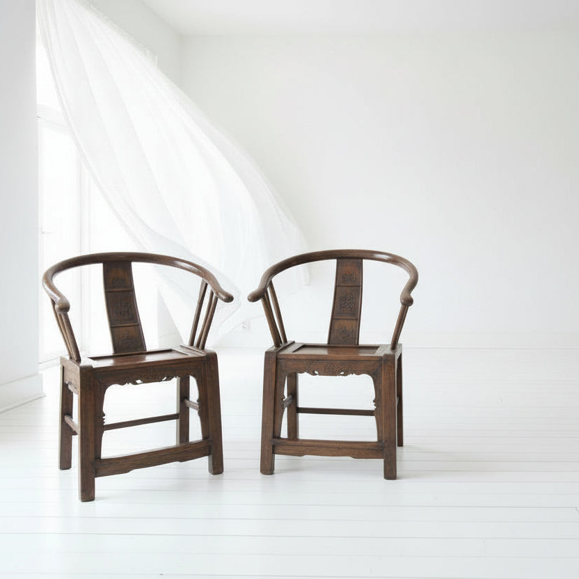 Two wooden chairs with a unique design on a white background