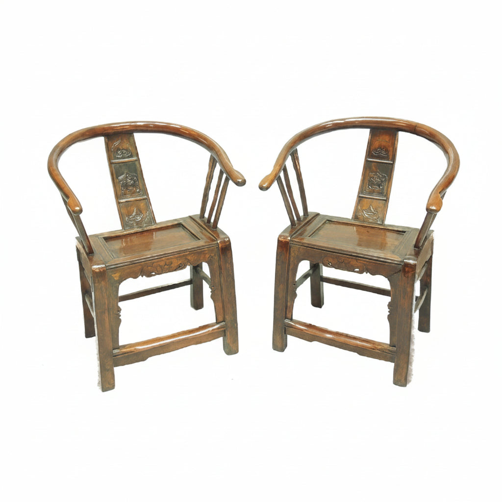 Two wooden chairs with intricate designs on a white background