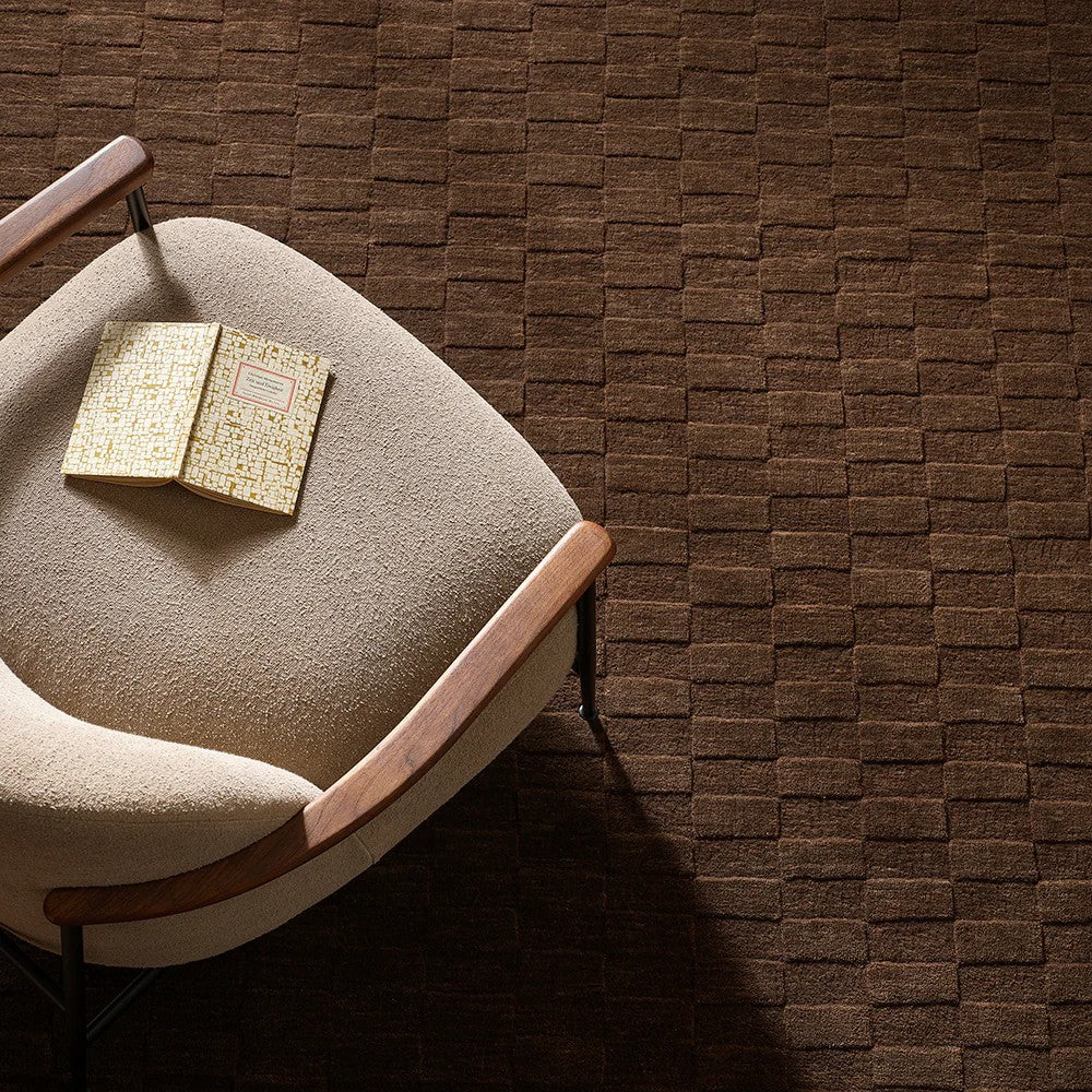 Espresso coloured and checkered patterned floor rug with a occasional chair 