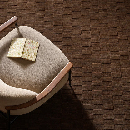 Espresso coloured and checkered patterned floor rug with a occasional chair 