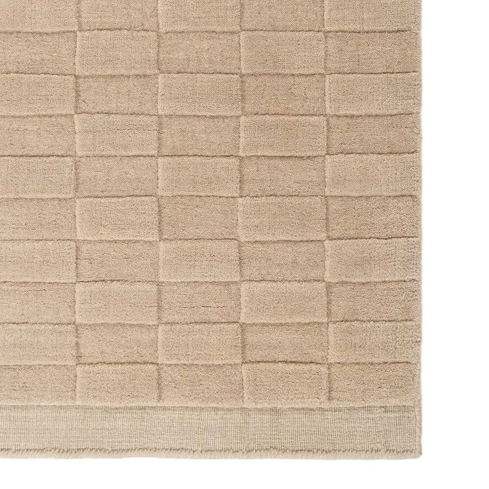 Textured almond ug with a checkered pattern on a white background