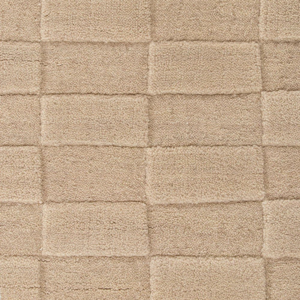 Close-up of a textured almond floor rug with a checkered pattern