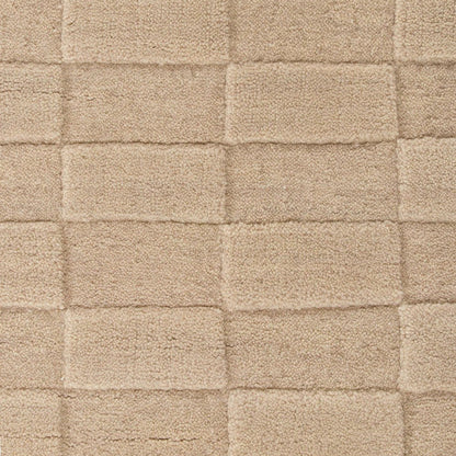 Close-up of a textured almond floor rug with a checkered pattern