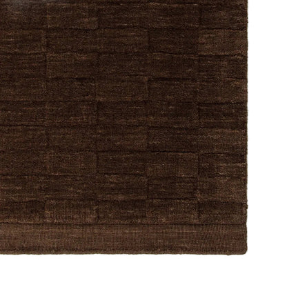 Close up espresso coloured floor rug on a white background