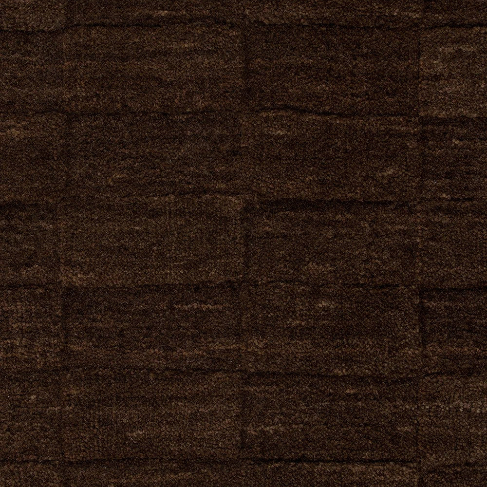 Close up of espresso coloured and checkered patterned floor rug 