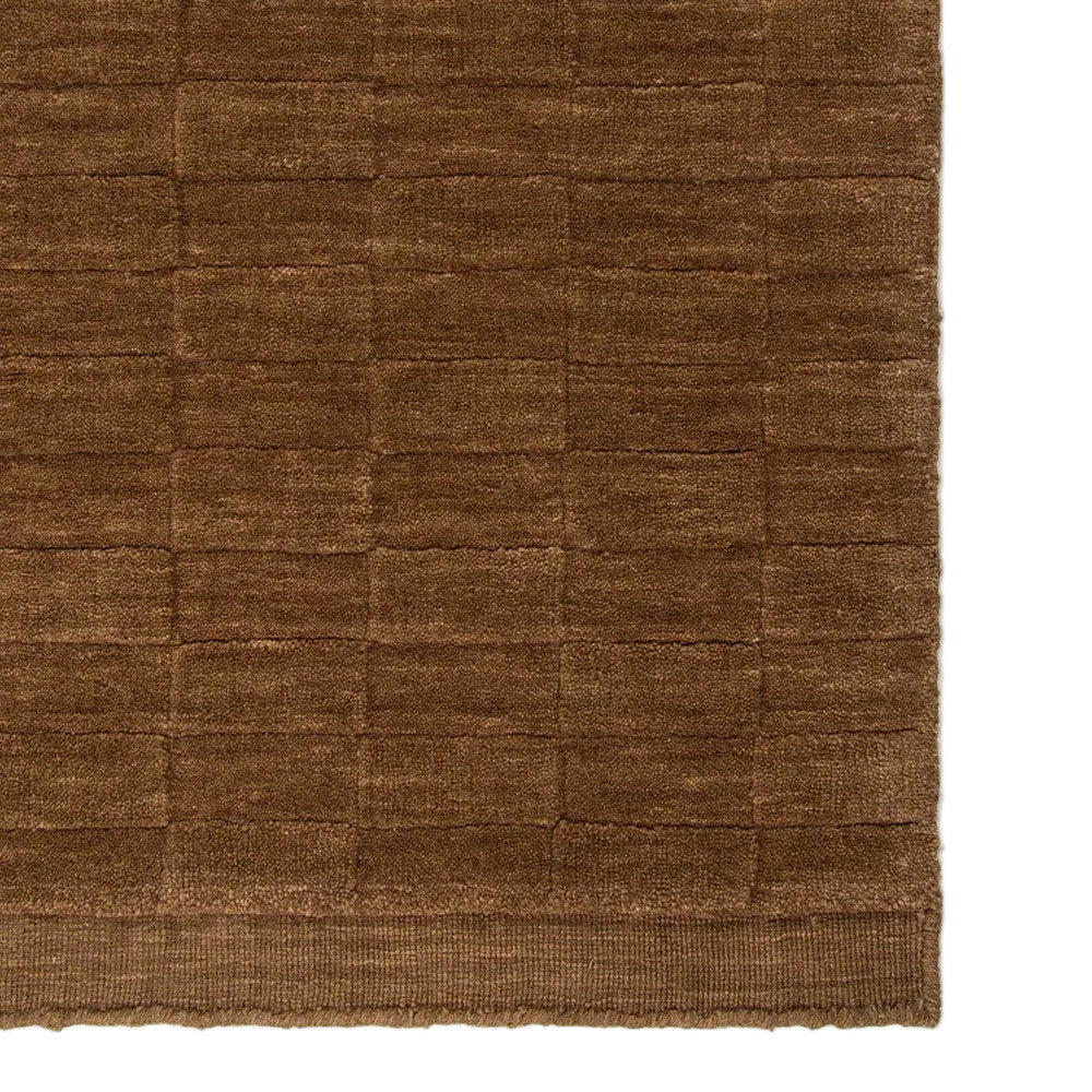 Toffee textured rug on a white background