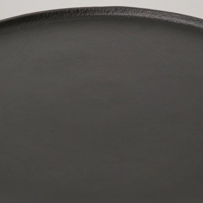 Close-up of a top detailing of a black side table showing its smooth matte surface and curved rim against a white background.