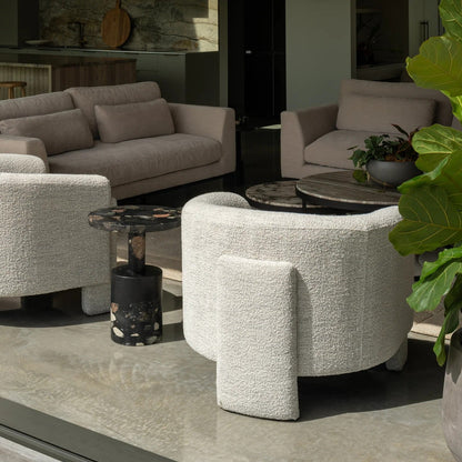 Modern furniture set with beige sofas and cream textured armchairs in a open lounge setting.