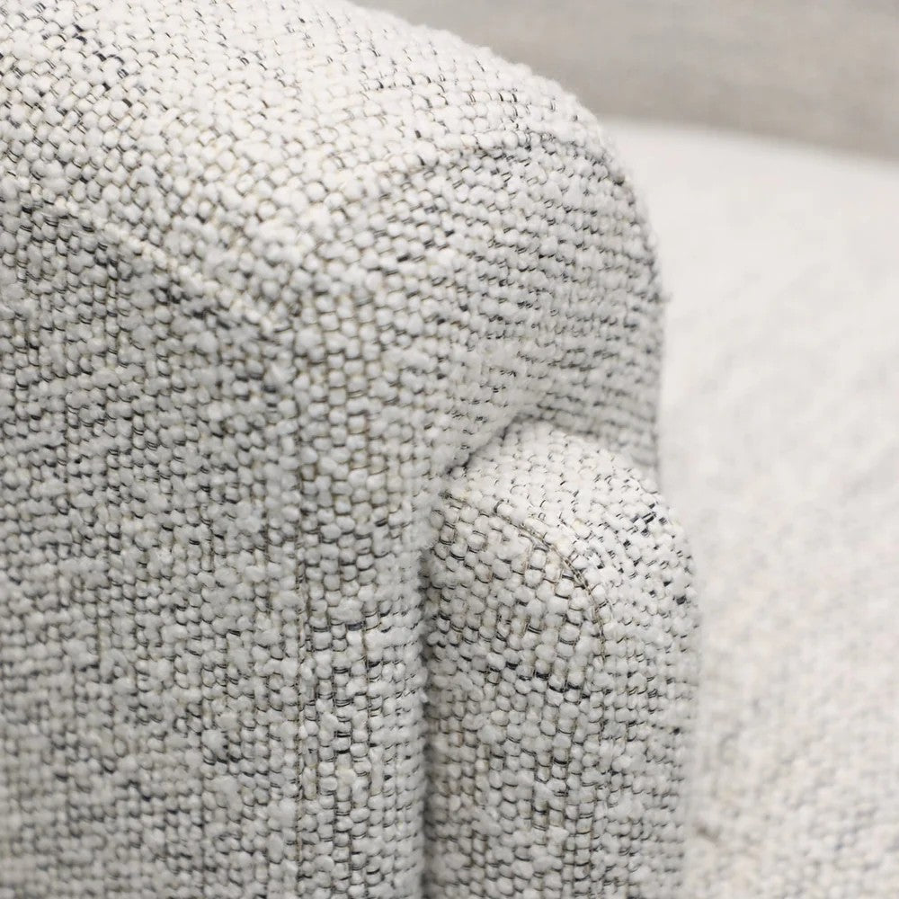 Close-up of textured cream fabric on an armchair 