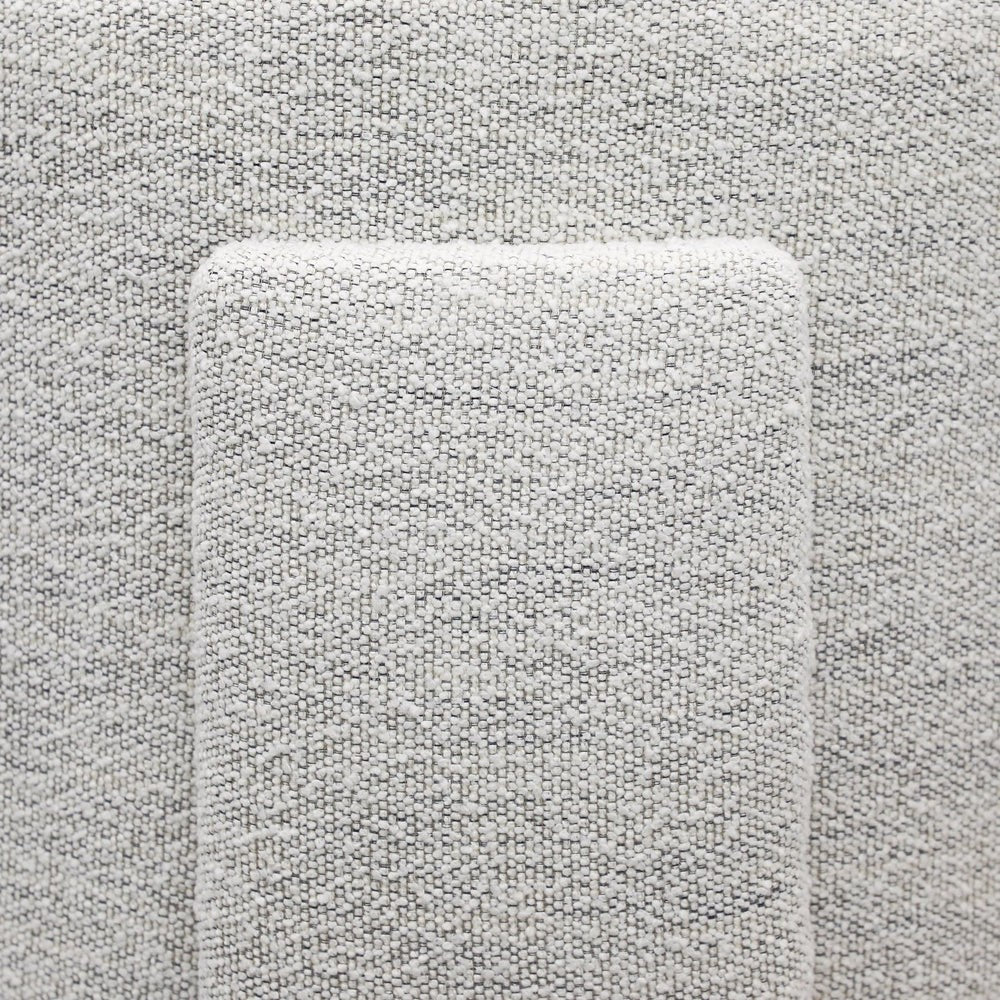 Close-up of back detailing on cream textured armchair 