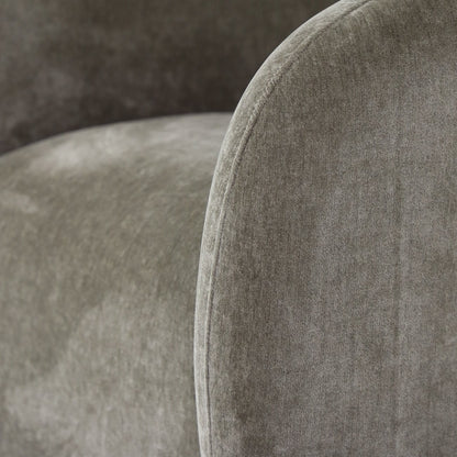 Close-up of a moss upholstered chair with a textured fabric surface.