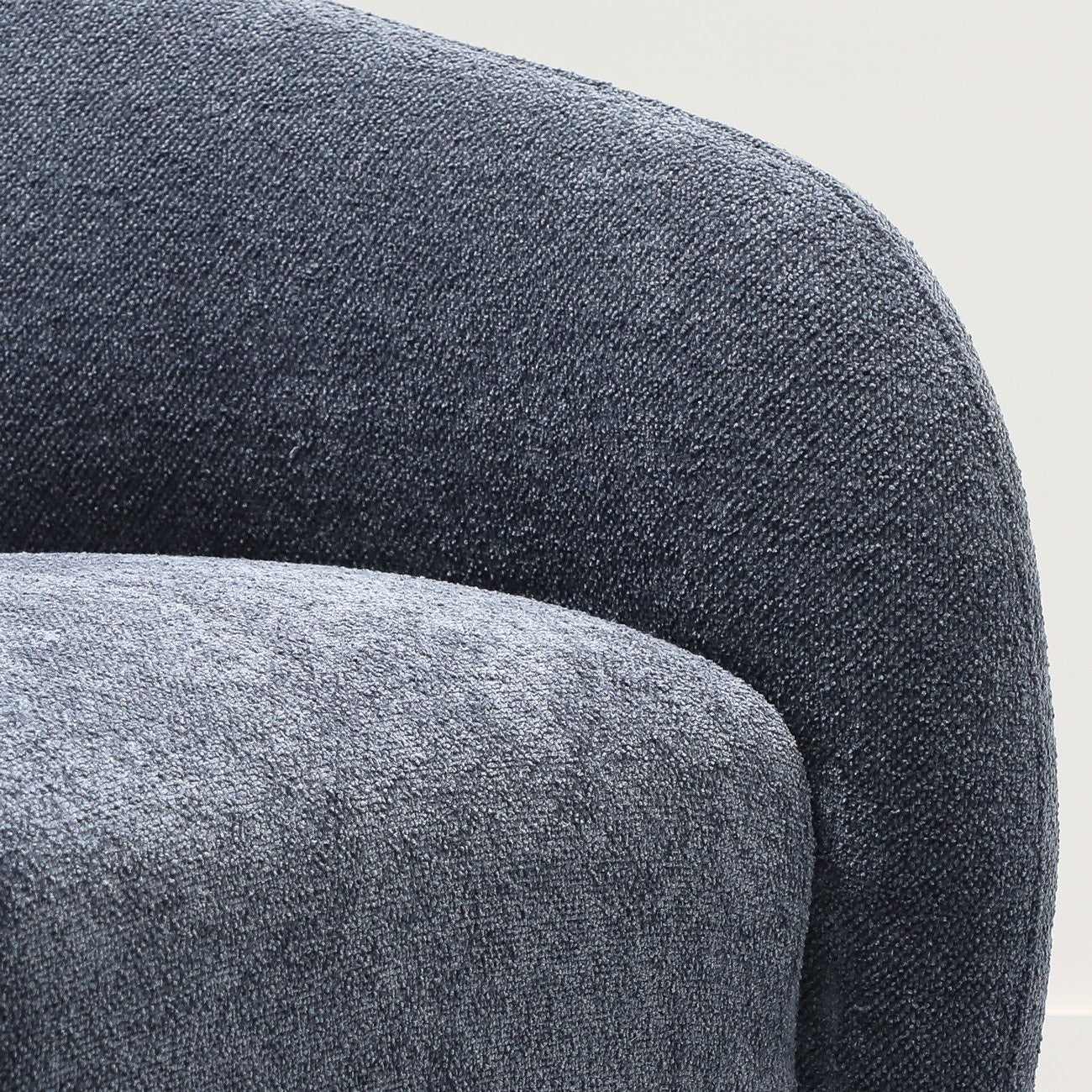 Close-up of a textured steel blue chair with a white background
