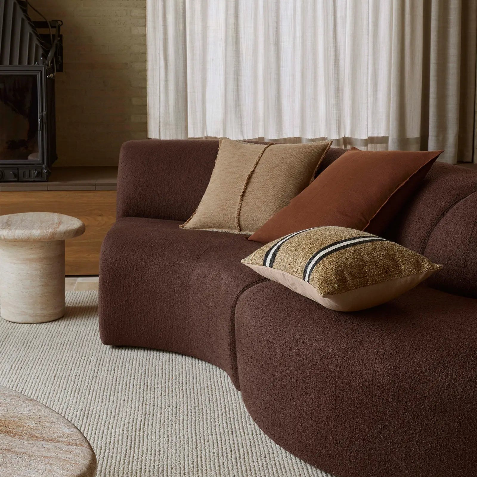Brown sofa with cushions in a modern living room setting