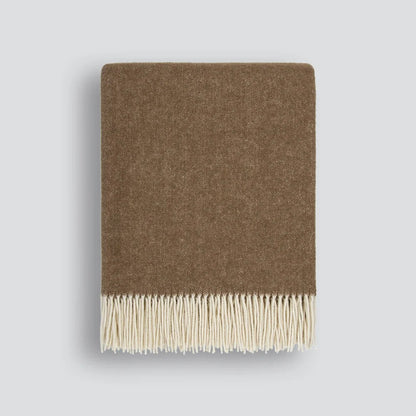 Brown blanket with cream fringe on a white background