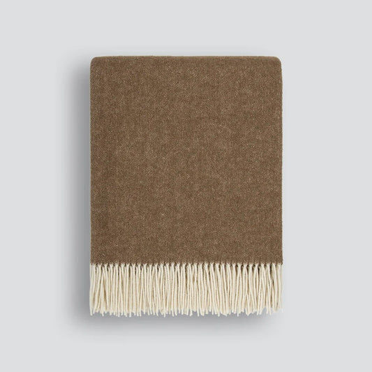 Brown blanket with cream fringe on a white background