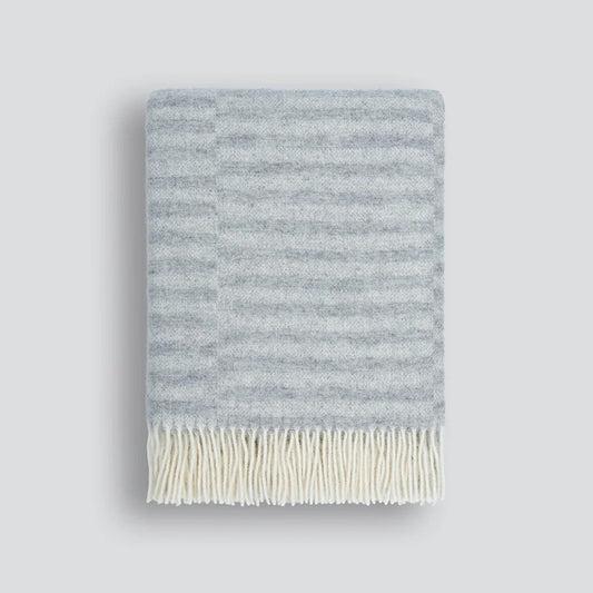 Striped silver grey throw blanket on a white background