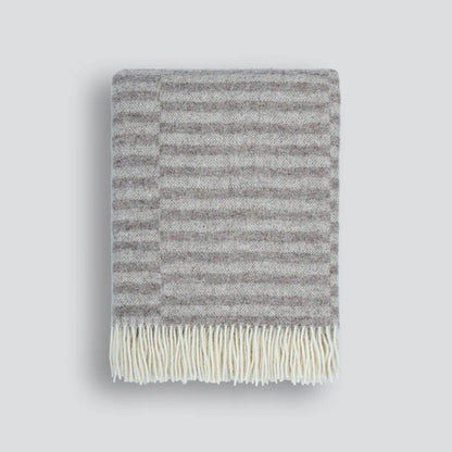 Oatmeal striped blanket with cream fringe on a white background