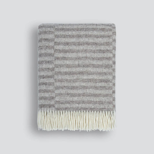 Oatmeal striped blanket with cream fringe on a white background