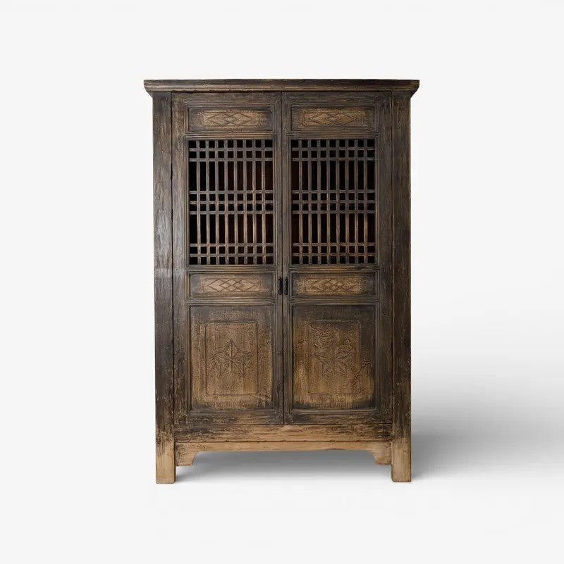 Nomad vintage wooden cabinet with intricate carvings on a white background