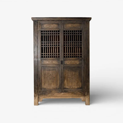 Nomad vintage wooden cabinet with intricate carvings on a white background