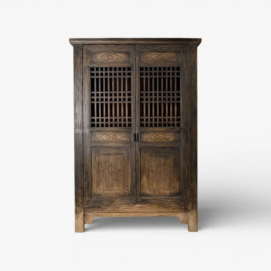 Nomad vintage wooden cabinet with intricate carvings on a white background