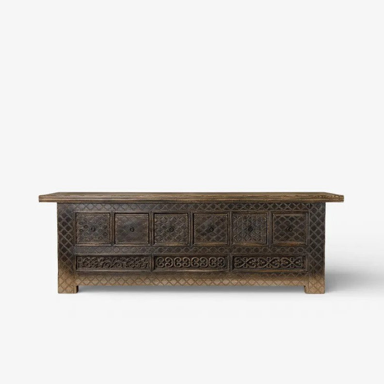 Nomad Low wooden Cabinet with intricate carvings on a white background