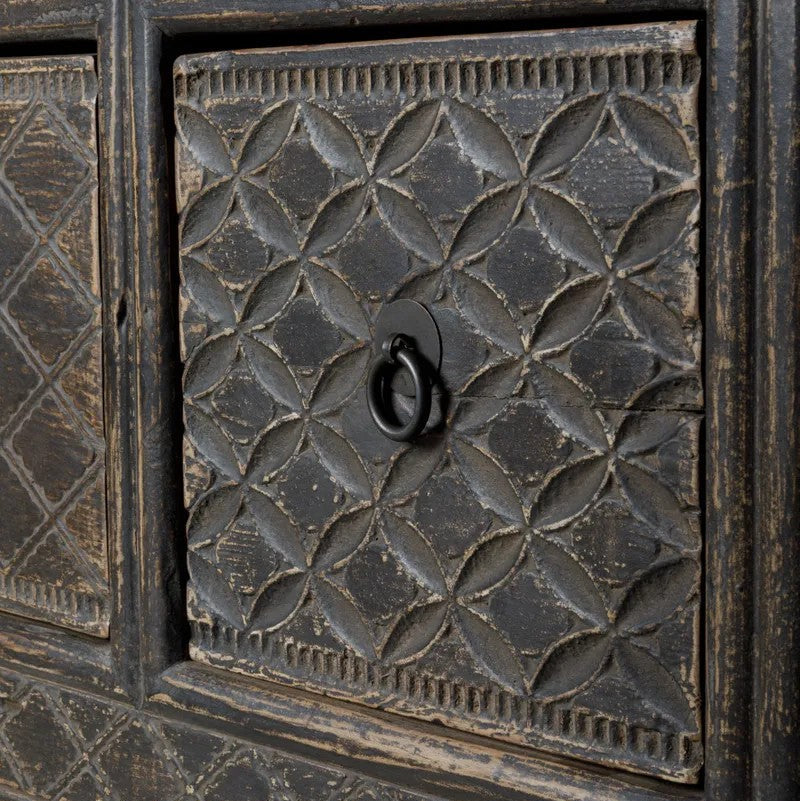 Decorative wooden drawer panel with geometric pattern and central handle on a textured background