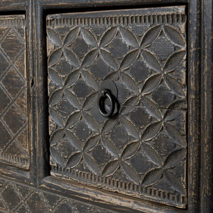 Decorative wooden drawer panel with geometric pattern and central handle on a textured background