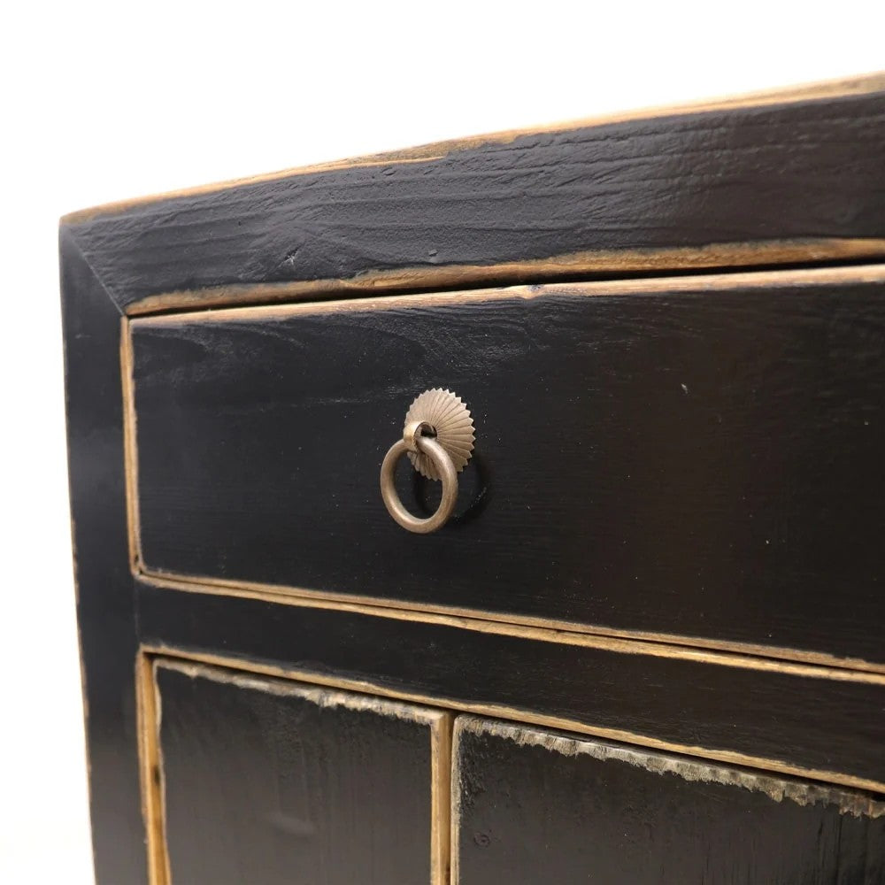 Close-up of a black wooden bedside cabinet (drawer) with a decorative ring handle on a white background
