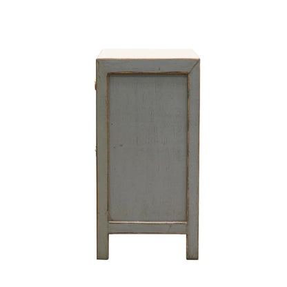 Side profile of small bedside cabinet with a distressed light grey painted finish, shown against a plain white background