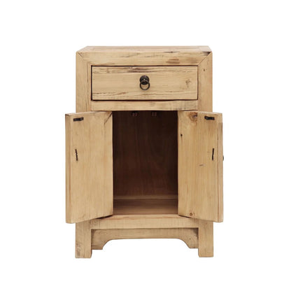 A small rustic wooden bedside cabinet with a single drawer on top and two doors swung open, showing an open shelf inside. The cabinet is made of light natural wood with visible grain and knots, featuring dark metal hardware.
