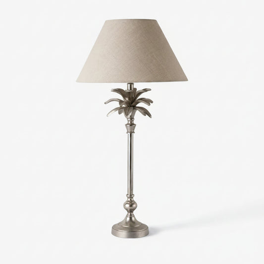Decorative table lamp with a palm leaf design on a white background