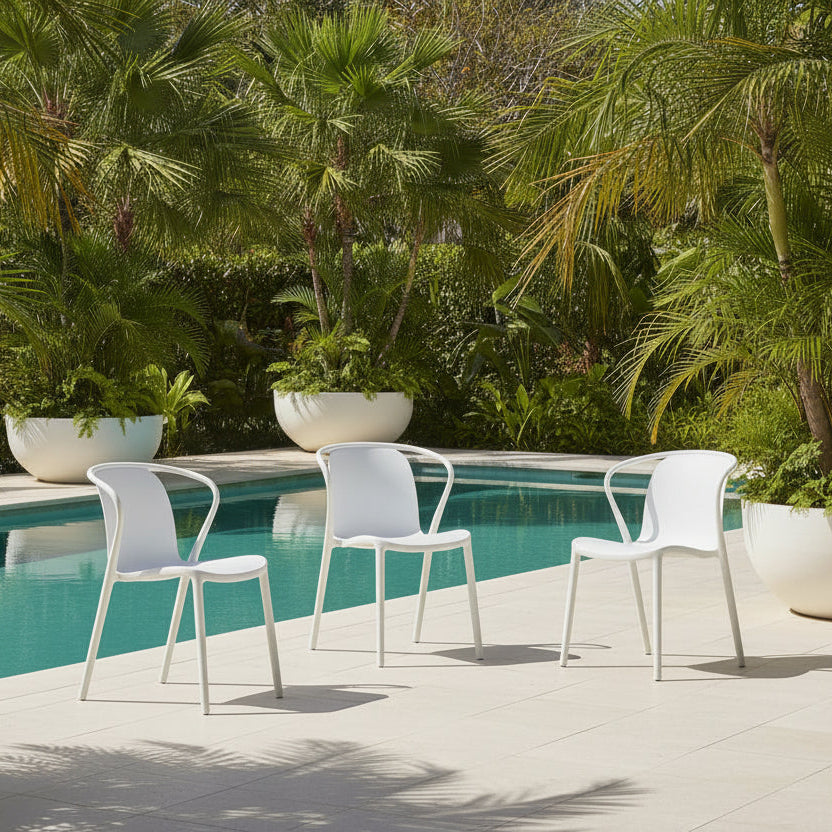 Roma white outdoor dining chair in a pool setting 