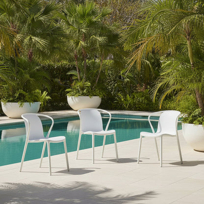 Roma white outdoor dining chair in a pool setting 