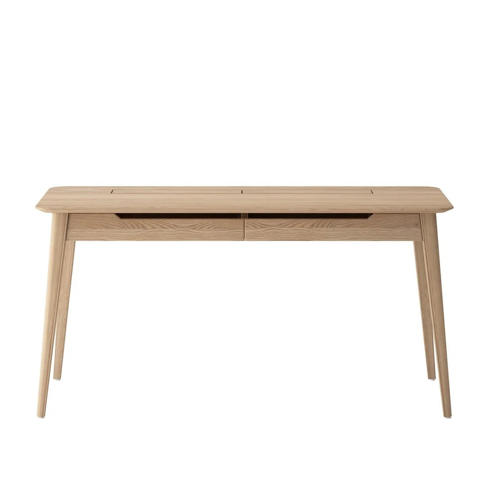 A light natural oak wood writing desk with tapered legs and a built-in cable management slot on the top surface, shown against a plain white background.