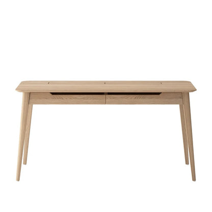 A light natural oak wood writing desk with tapered legs and a built-in cable management slot on the top surface, shown against a plain white background.
