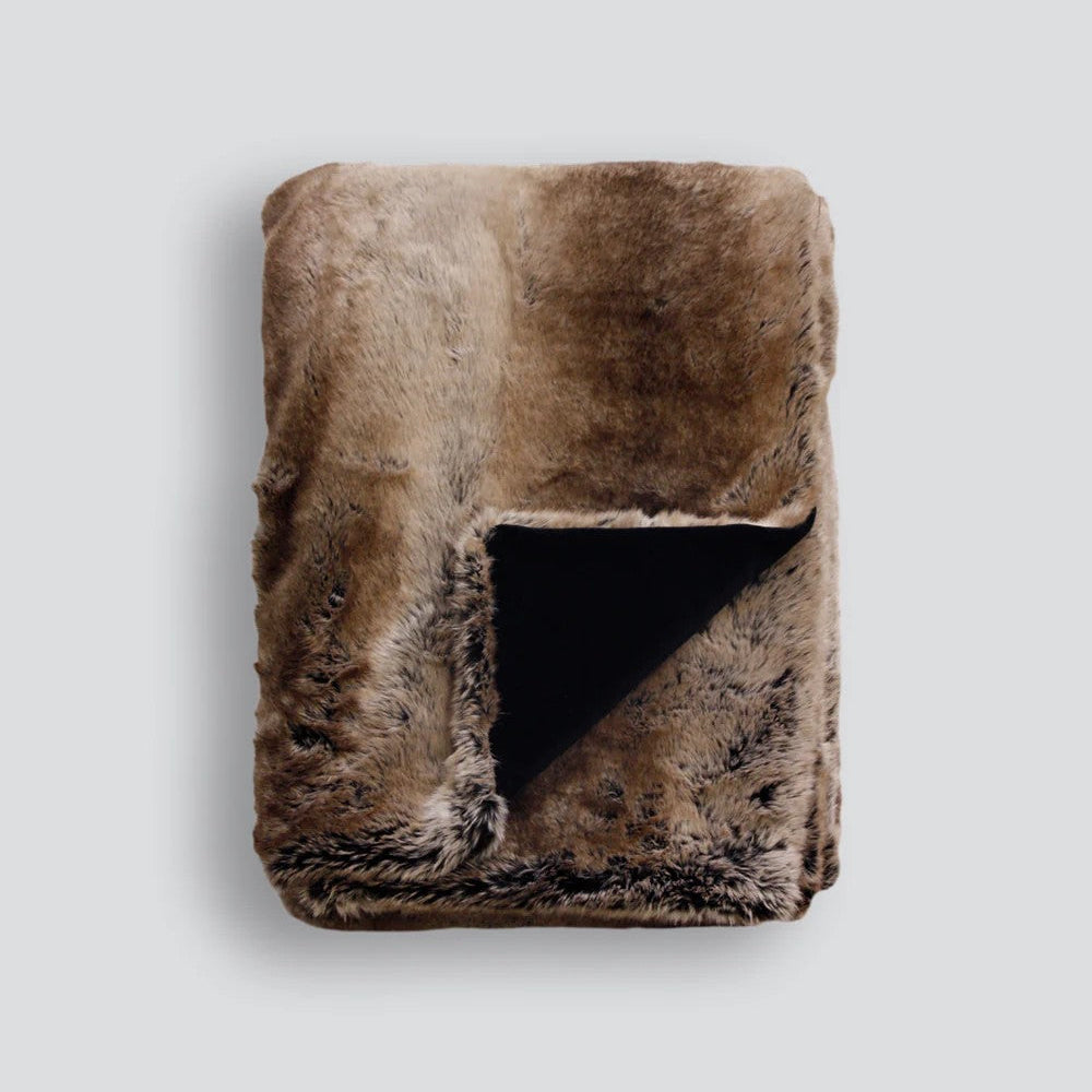 Sable faux fur throw blanket on a light grey background