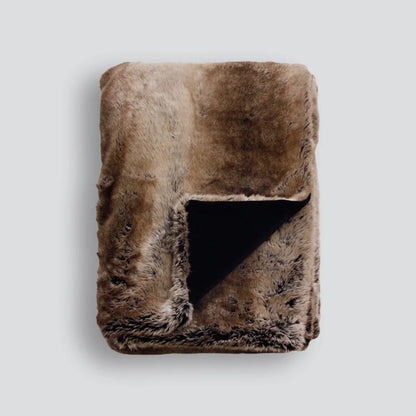 Sable faux fur throw blanket on a light grey background