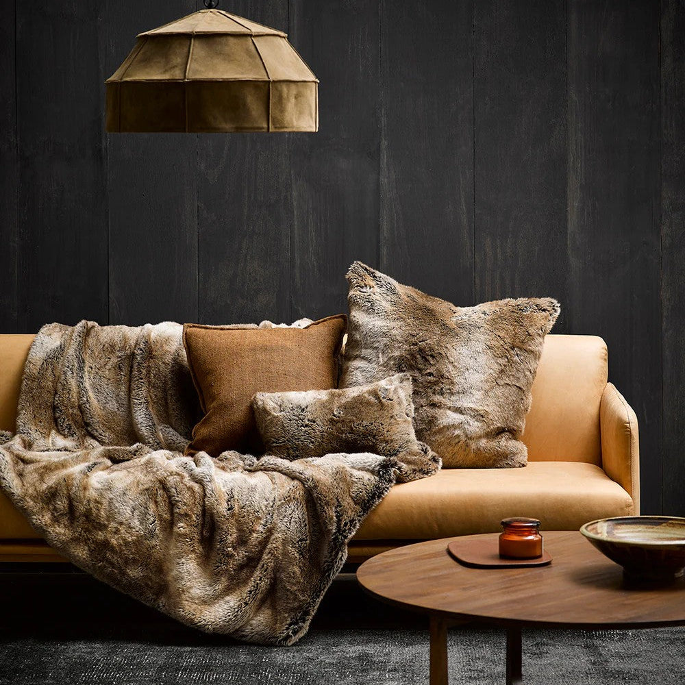 Cosy living room with a beige sofa, Sable fur throw, and Sable Cushions against a dark wall.