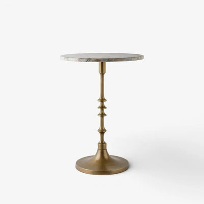A round side table with a light gray marble top and a decorative antique brass pedestal base, shown against a plain white background.