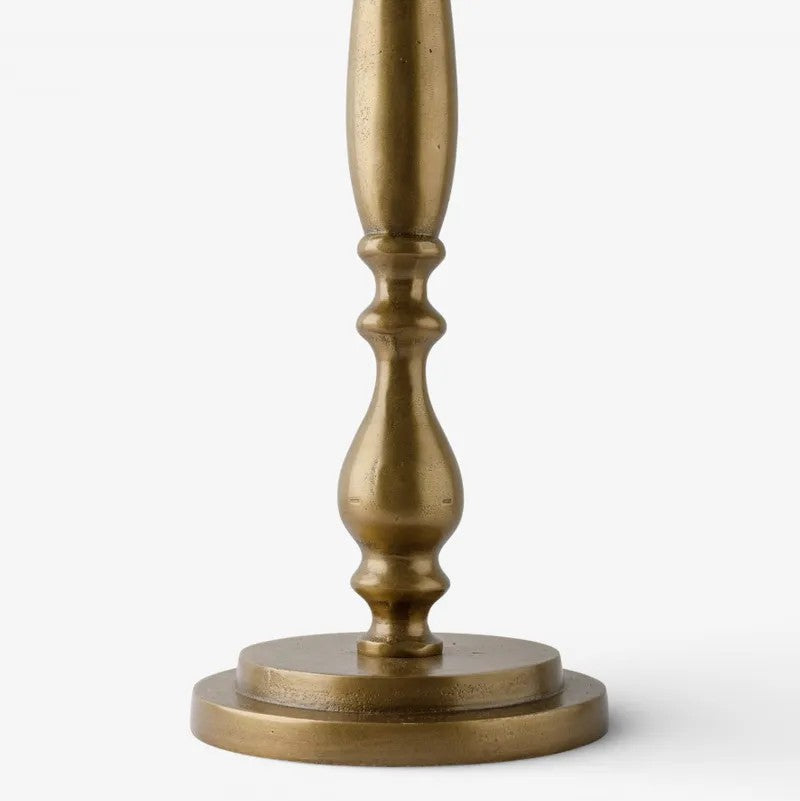 close up on Antique Brass finish on the Sutton Side Table base on a white background